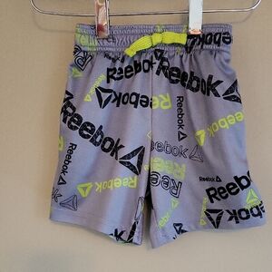 Reebok grey athletic shorts with neon green accents